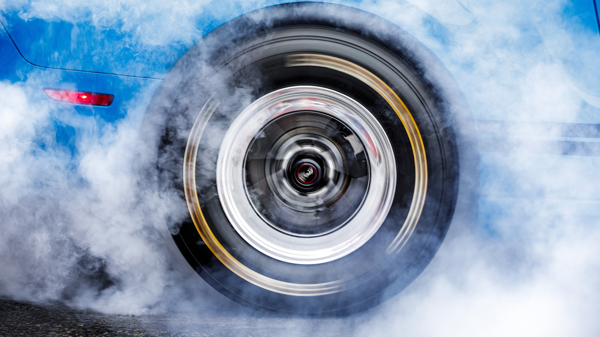 Blue sports car tire with smoke, spinning at high speed on a street. Cars for kids. Mr. Machine kids show. 