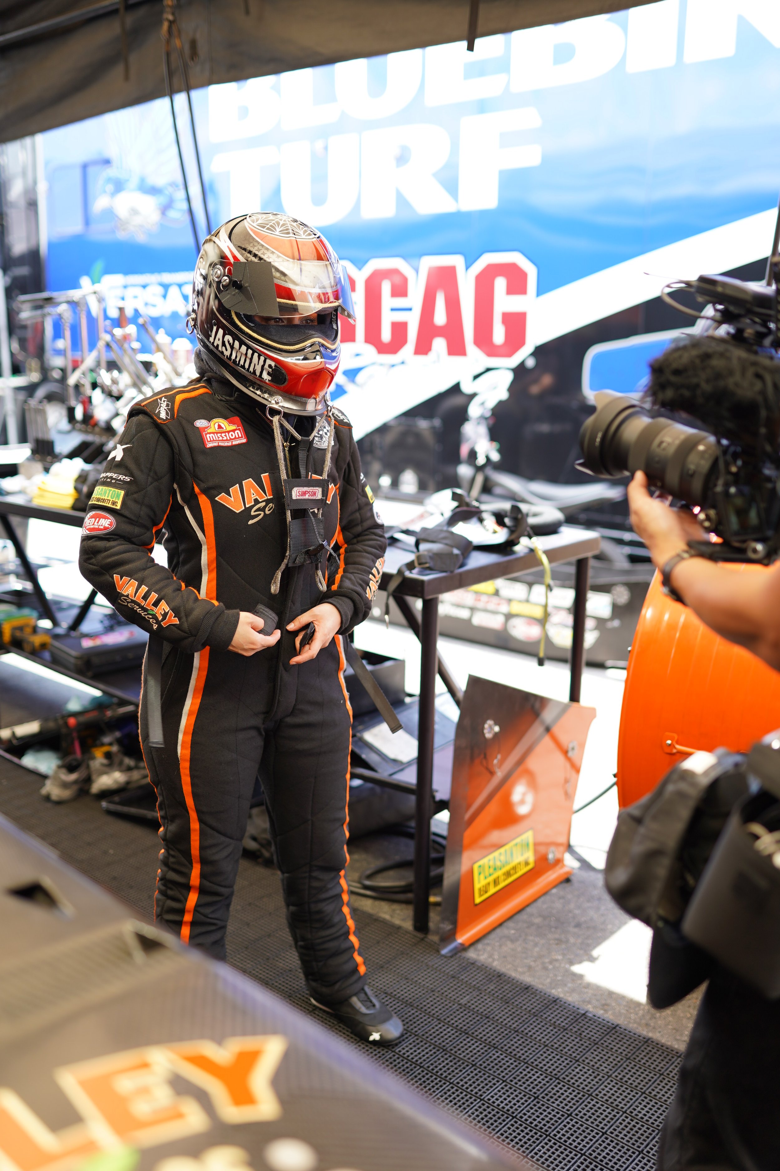 Race car driver, Jasmine Salinas, being filmed for The Mr. Machine Show. BTS of The Mr. Machine Show. Behind-the-Scenes of The Mr. Machine Show with Tay Whiteside. NHRA Drag Racing at the Charlotte 4-Wide Drag Race. 