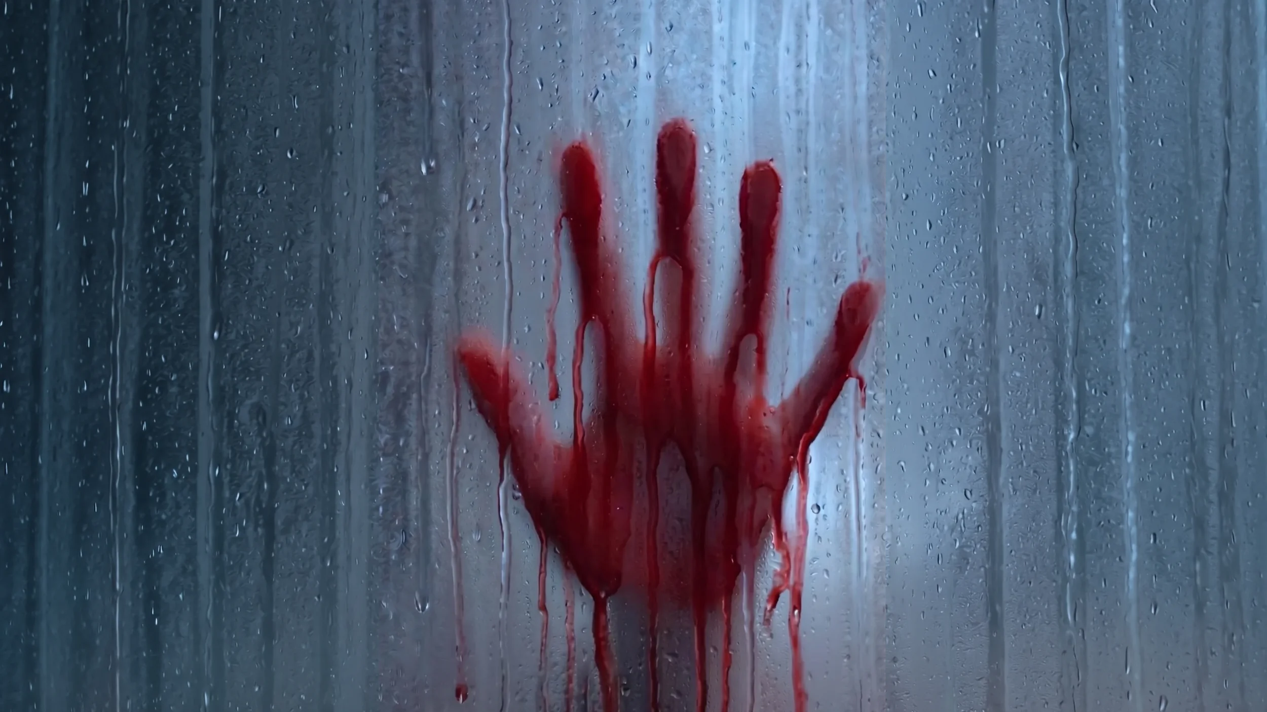 A hand covered in blood pressed against a foggy, wet glass surface, with streaks of blood running down the glass.