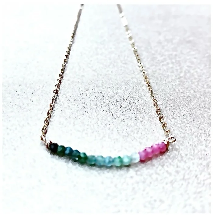 To celebrate equality + each other, and the myriad of life&rsquo;s colors, a bar of rainbow tourmaline is embraced by arms of gold #tourmaline #rainbow #pride