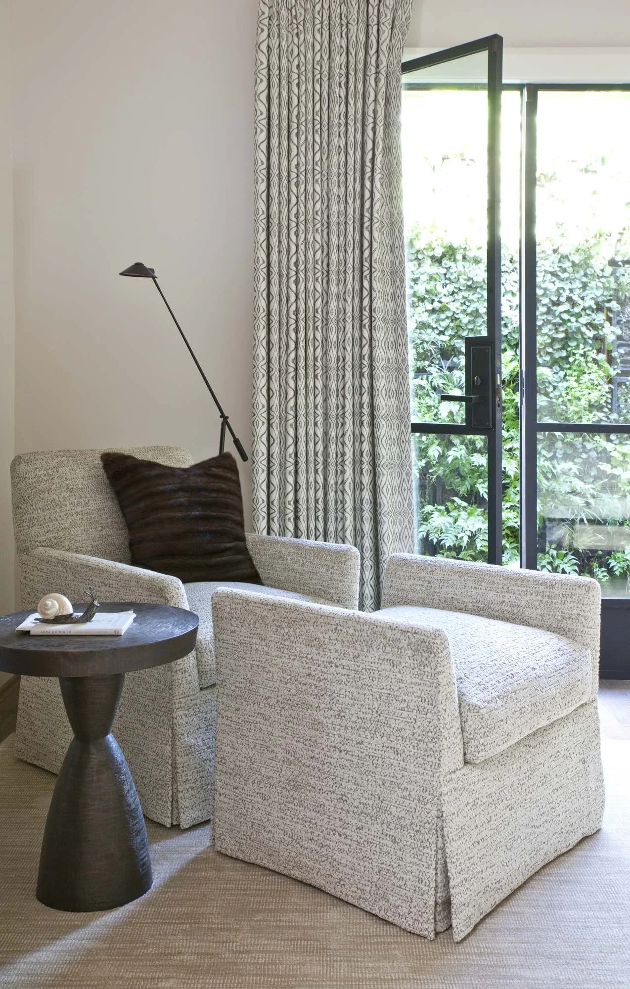 millwalk-atlanta-residential-interior-design-bedroom-sitting-area-swivel-chairs-steel-door-garden.jpg