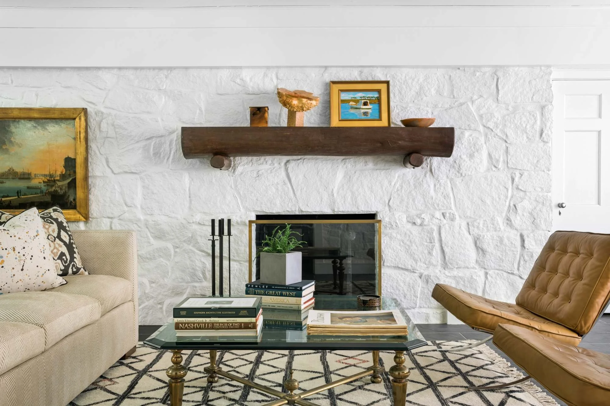 main-house-atlanta-residential-interior-design-den-white-stone-fireplace-leather-chair.jpg