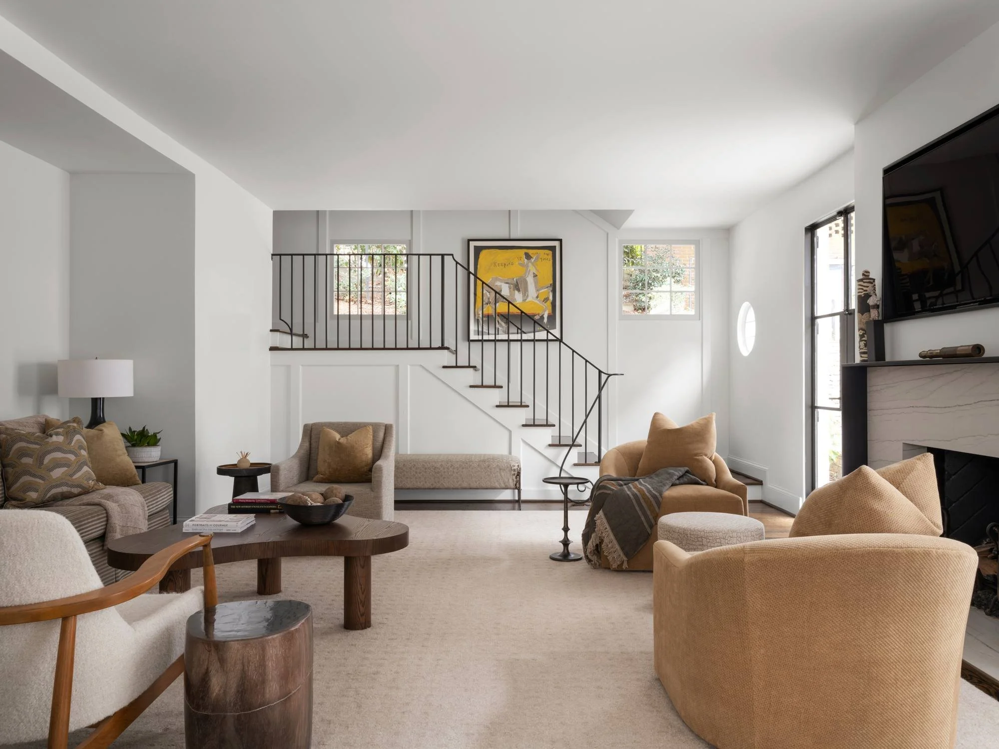 Peachtree-Battle-family-room-ochre-swivel-chairs-open-staircase-marble-fireplace.jpg