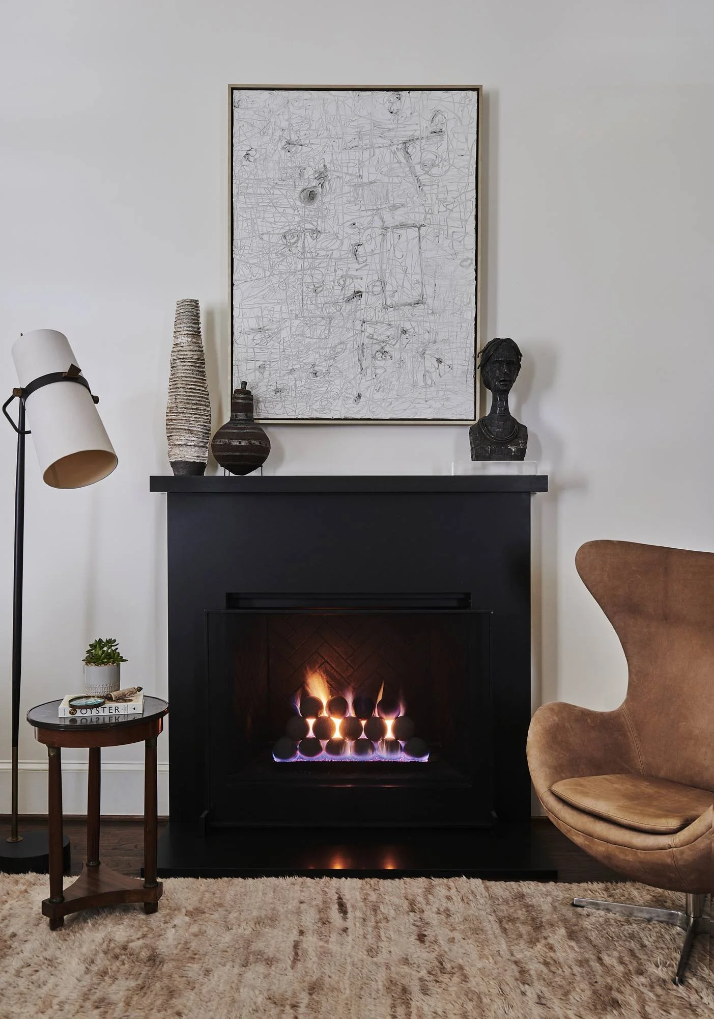 atlanta-luxury-interior-design-black-fireplace-egg-chair-abstract-art.jpg