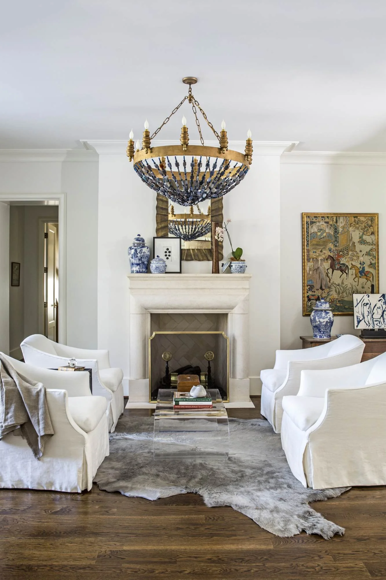 formal-living-room-stone-fireplace-brass-beaded-chandelier.jpg