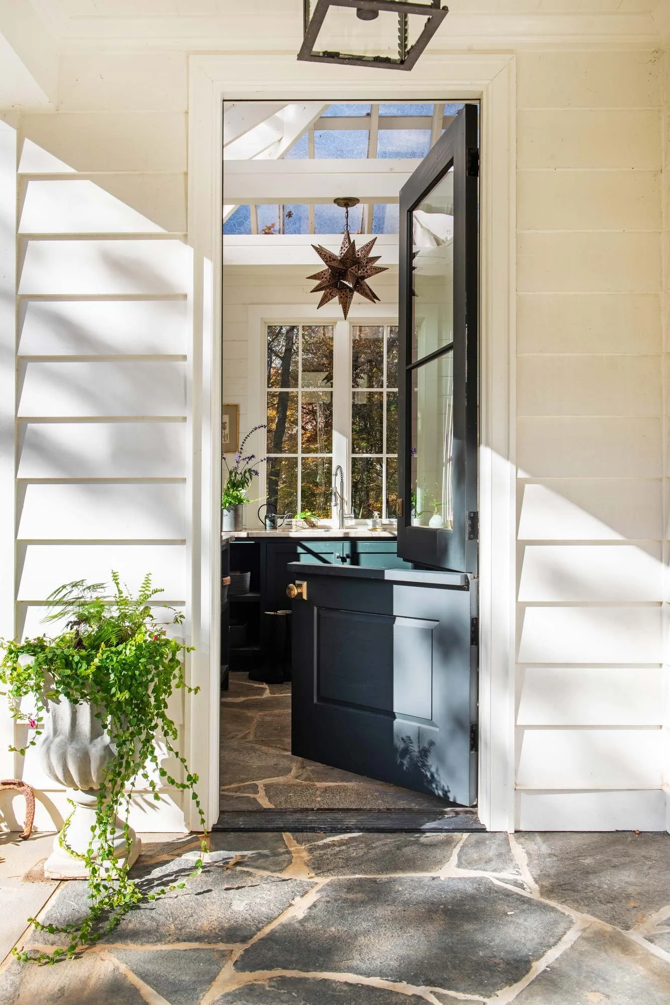 potting-shed-scout-house-atlanta-residential-interior-design-doorway-greenhouse-star-pendant.jpg
