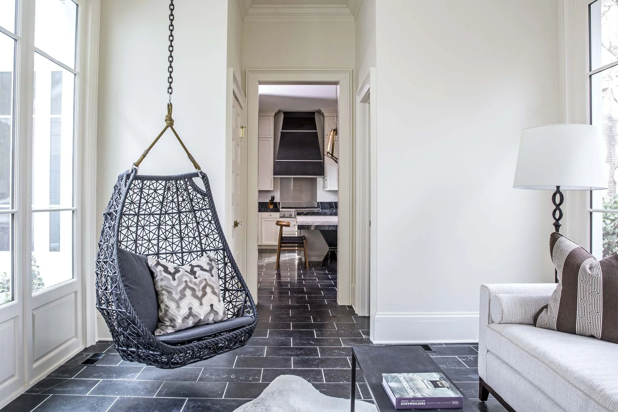 ansley-atlanta-residential-interior-design-sunroom-hanging-chair-view-to-kitchen.jpg