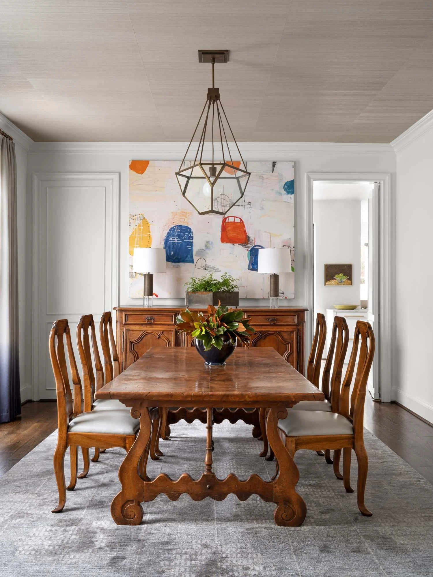 Peachtree-Battle-dining-room-antique-table-colorful-abstract-art-geometric-pendant.jpg
