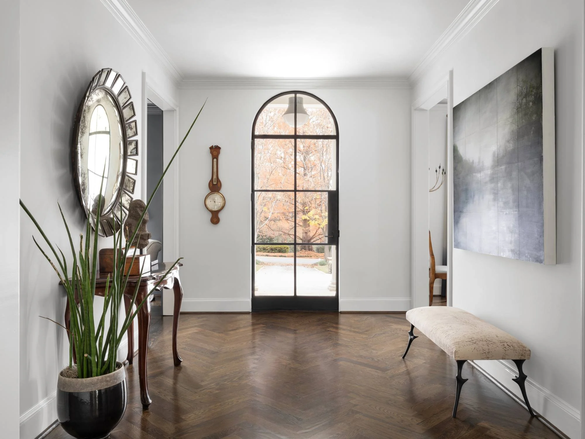 Peachtree-Battle-entry-foyer-herringbone-floors-arched-steel-door.jpg