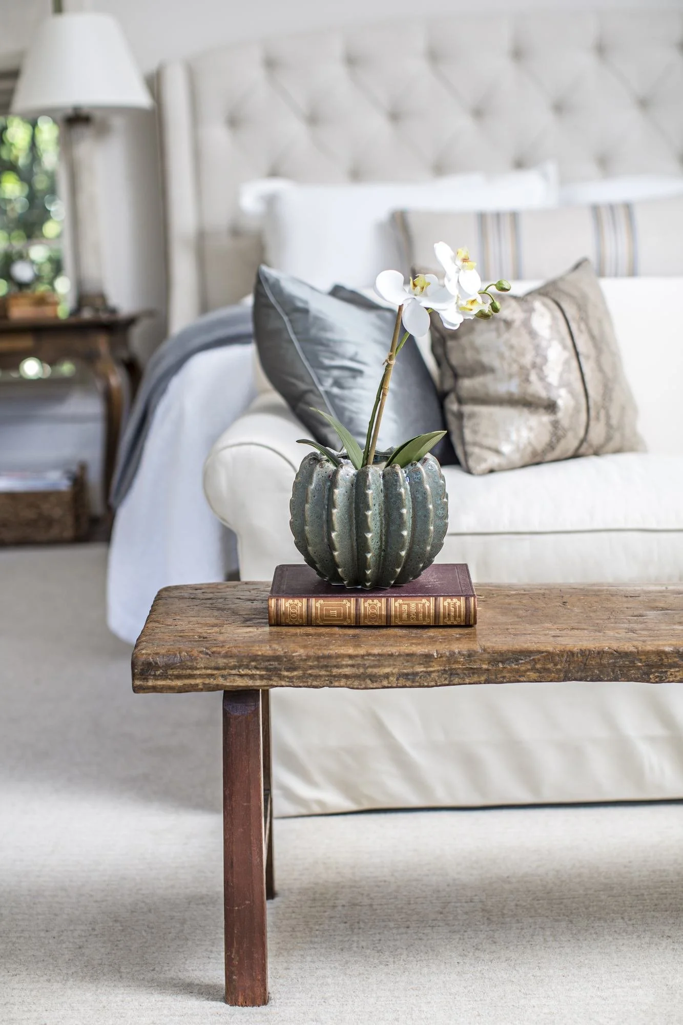 bedroom-bench-orchid-vase-tufted-upholstered-headboard.jpg