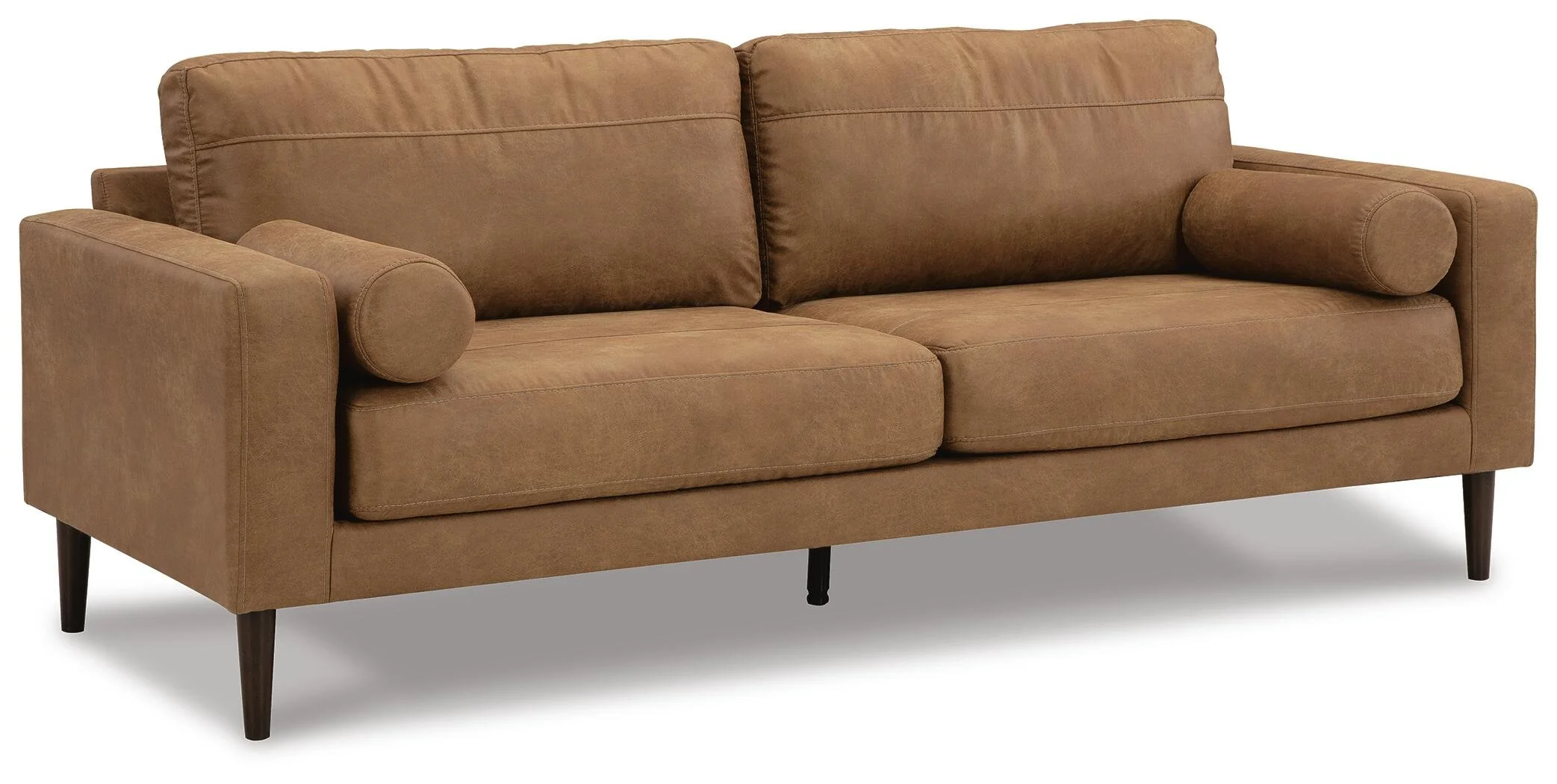 Modern sofa with warm caramel faux leather upholstery, plush loose cushions, bolster pillows, and faux wood accent legs.