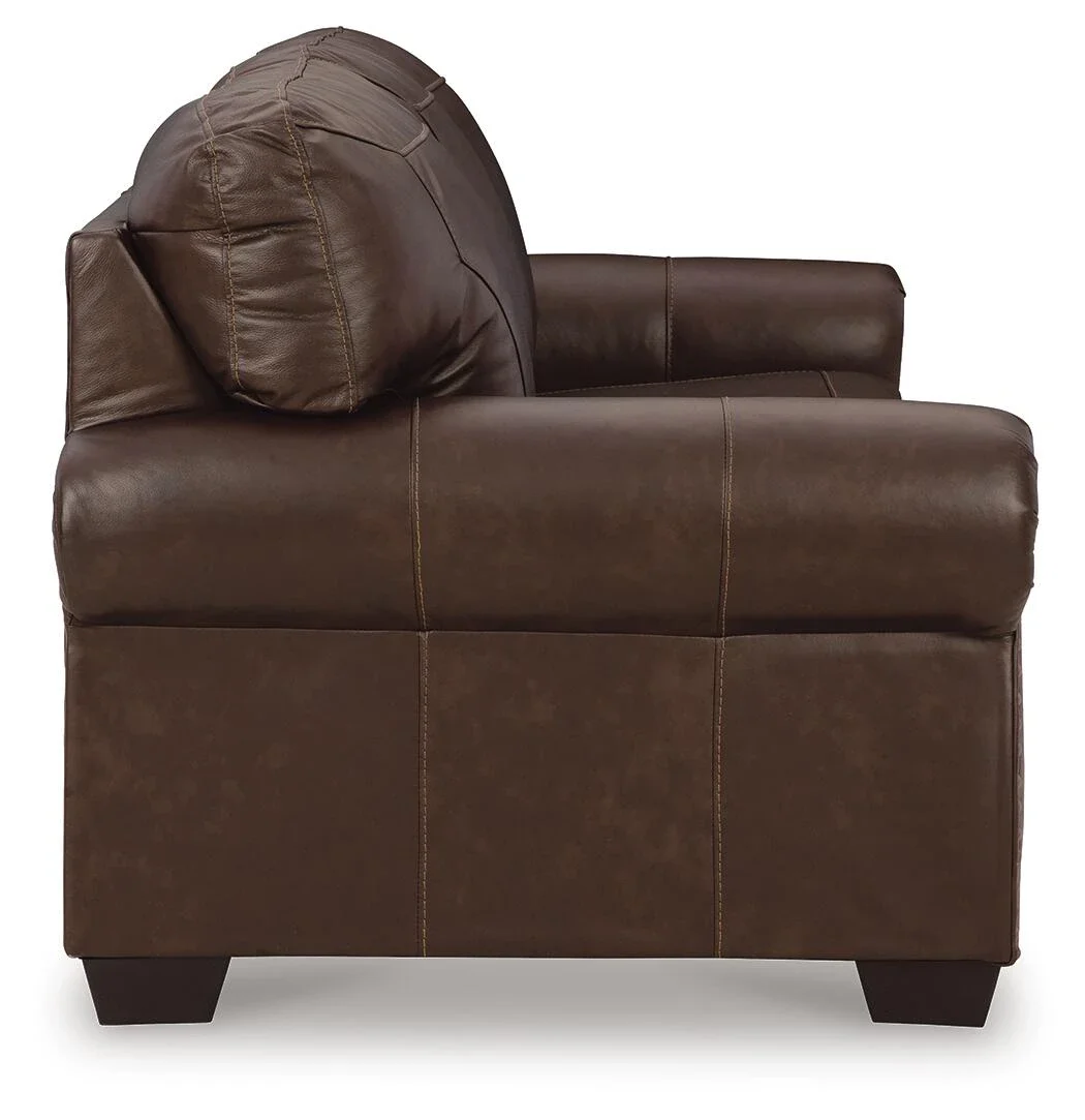 Traditional leather sofa with top-grain leather seating, classic roll arms, decorative nailhead trim, and plush cushions.