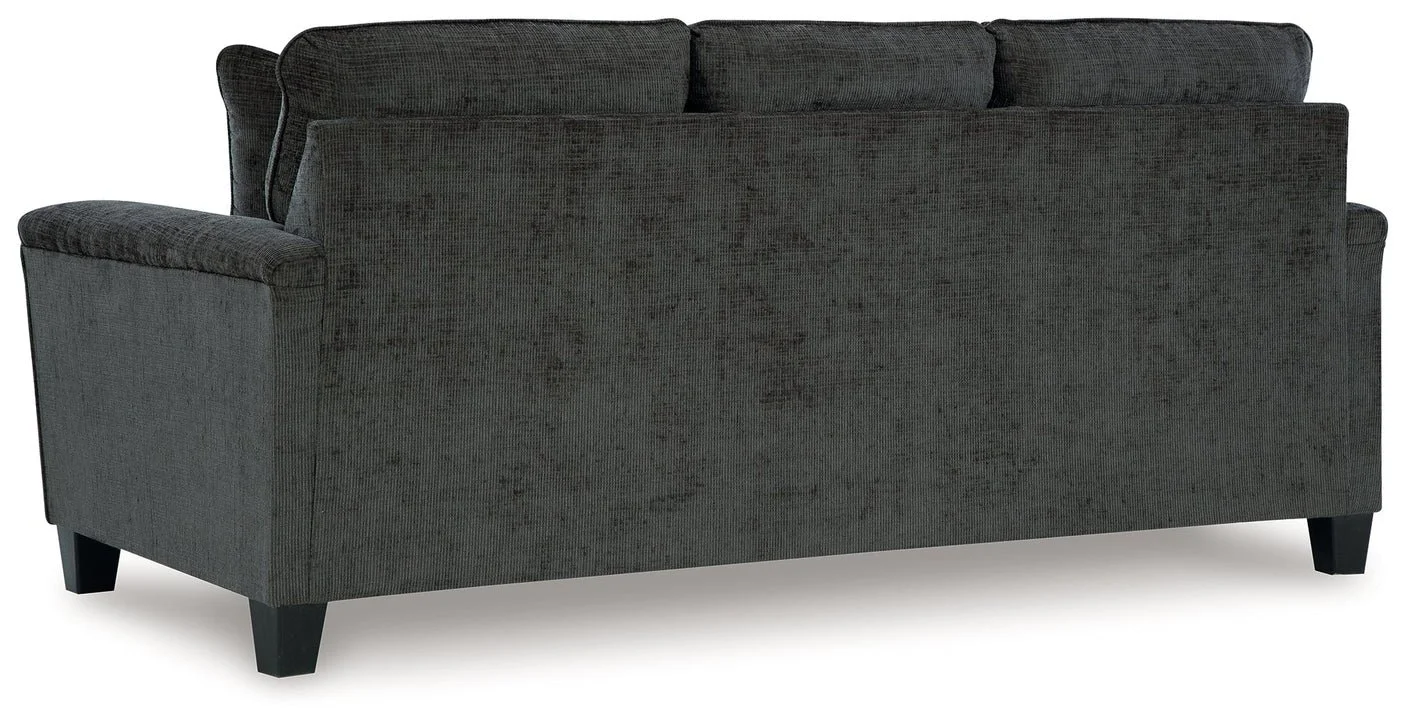 Contemporary sofa with soft polyester upholstery, tapered faux wood legs, and coordinating accent pillows.