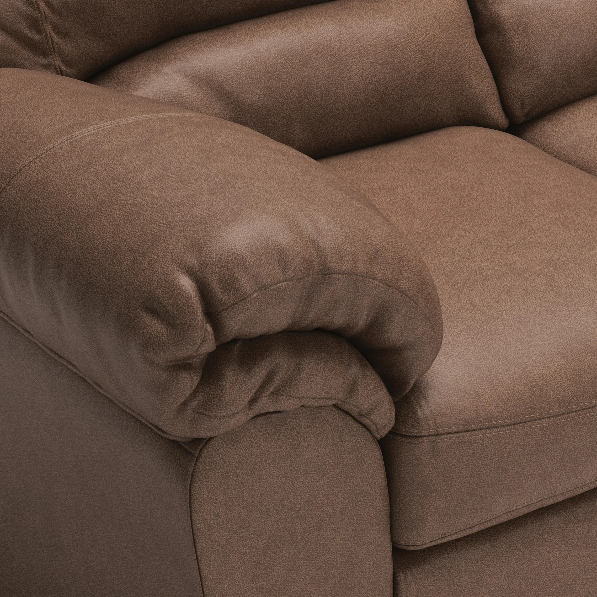 Close-up of the Weston sectional showcasing the faux leather upholstery, jumbo stitching, plush cushions, and quality craftsmanship.
