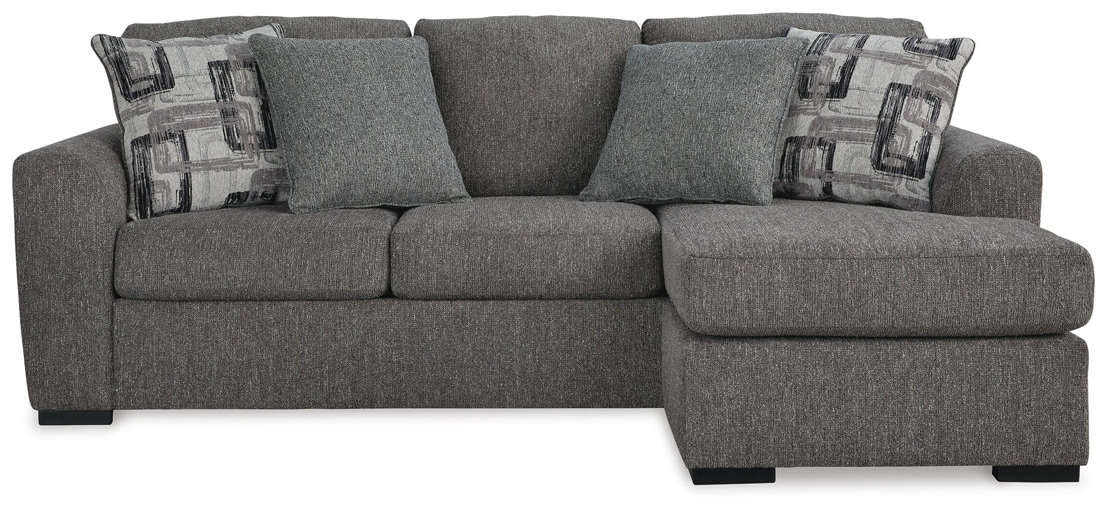 Contemporary reversible sofa chaise with soft polyester upholstery, movable ottoman, plush cushions, and oversized seating.