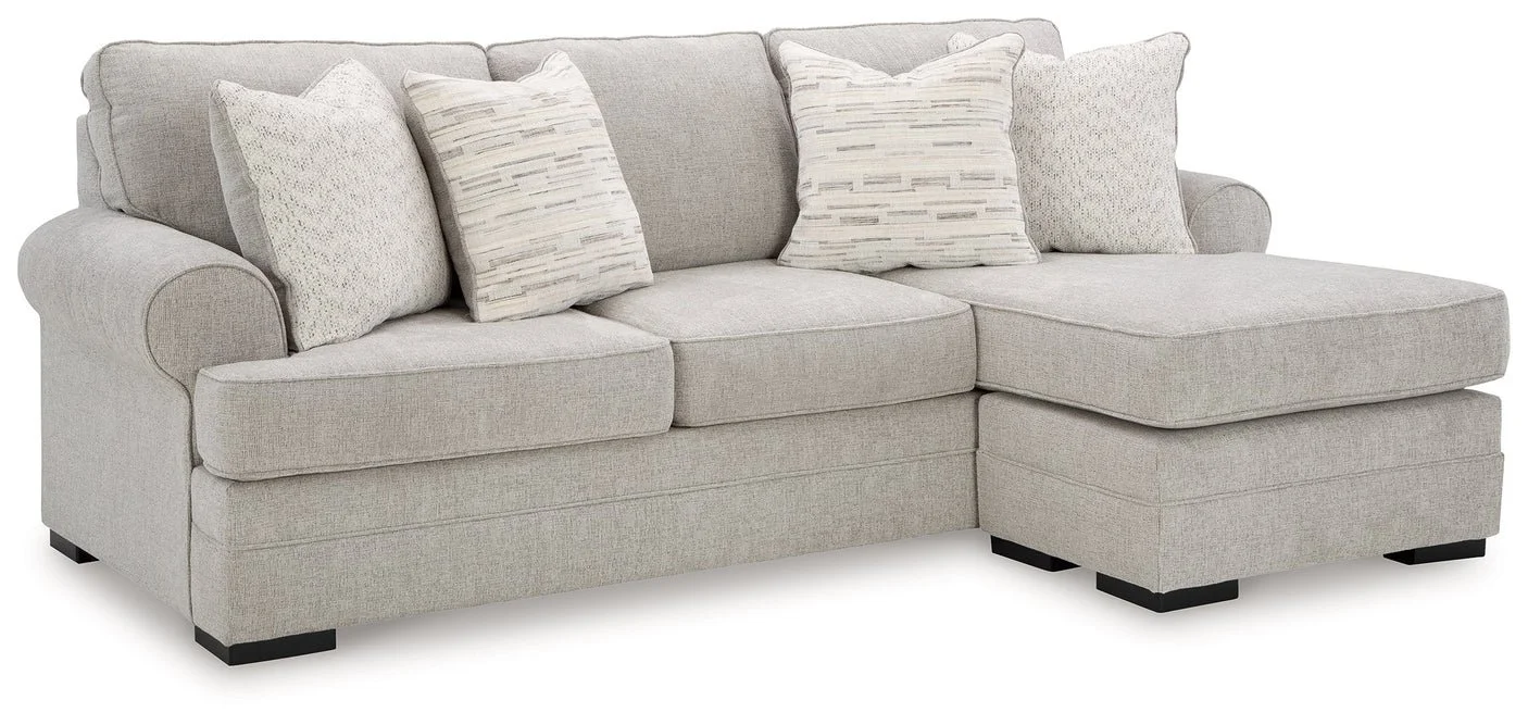 Modern reversible sofa chaise with textured polyester upholstery, movable ottoman, plush cushions, and contemporary styling.
