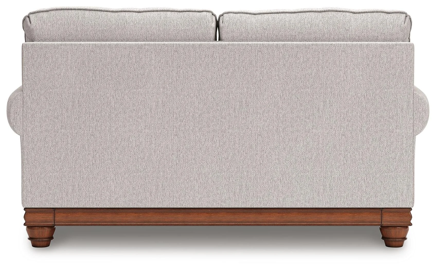 Matching farmhouse loveseat with soft neutral upholstery, reversible cushions, decorative turned legs, and coordinating accent pillows.