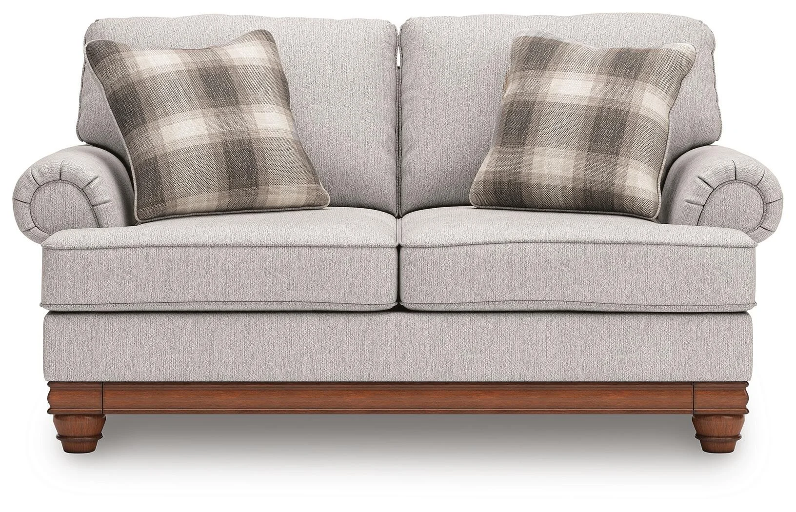 Matching farmhouse loveseat with soft neutral upholstery, reversible cushions, decorative turned legs, and coordinating accent pillows.