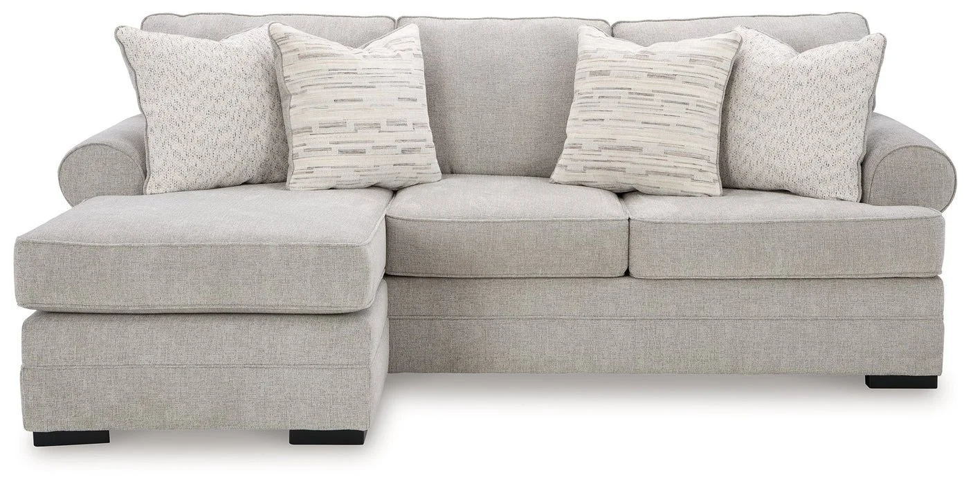 Modern reversible sofa chaise with textured polyester upholstery, movable ottoman, plush cushions, and contemporary styling.