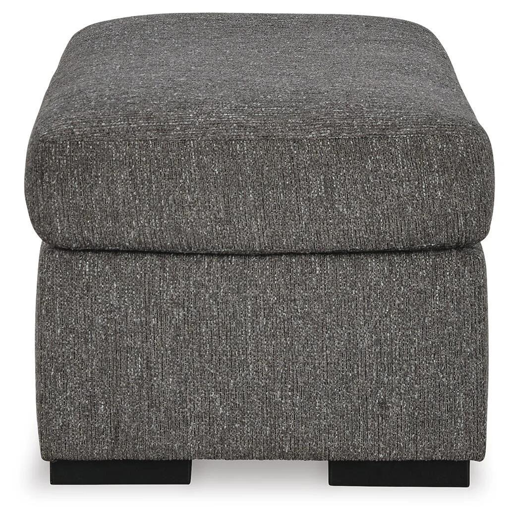 Matching upholstered ottoman with soft polyester fabric, firm foam cushioning, and faux wood feet.