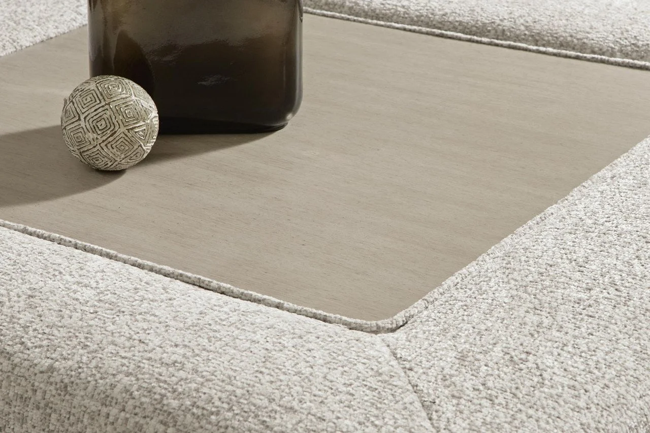 Matching oversized boucle ottoman with plush cushioning and a removable faux wood-look tray table.