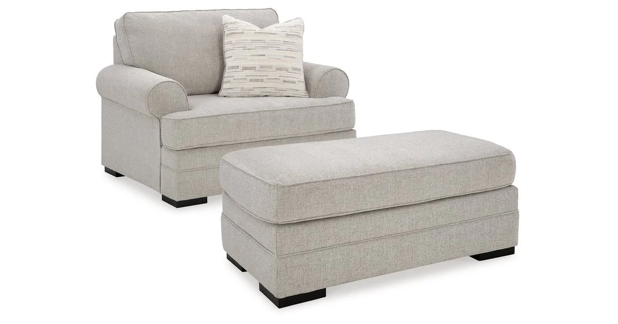 Oversized upholstered chair with textured polyester fabric, reversible seat cushion, plush accent pillow, and supportive foam cushioning.