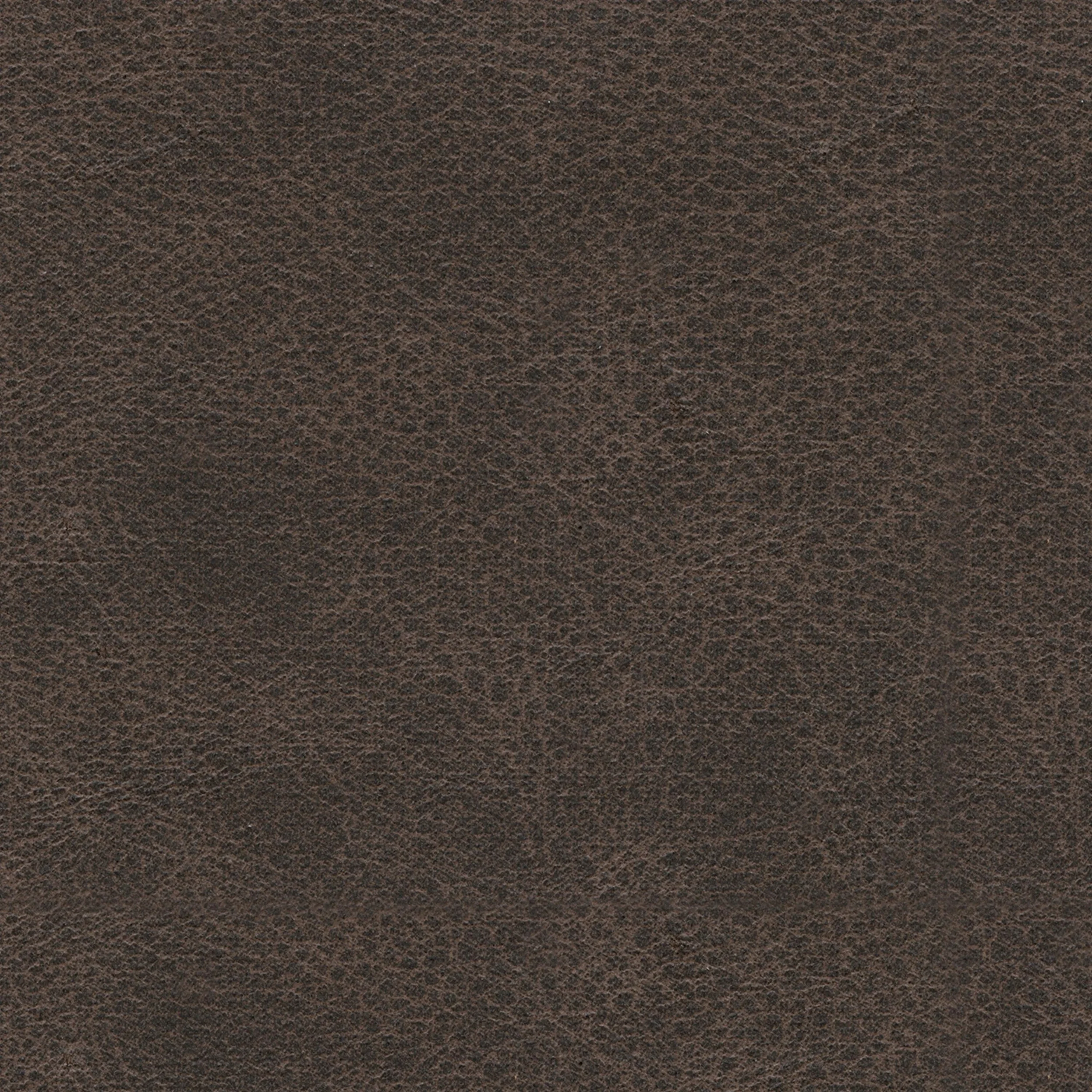 Close-up of the Weston sectional showcasing the faux leather upholstery, jumbo stitching, plush cushions, and quality craftsmanship.