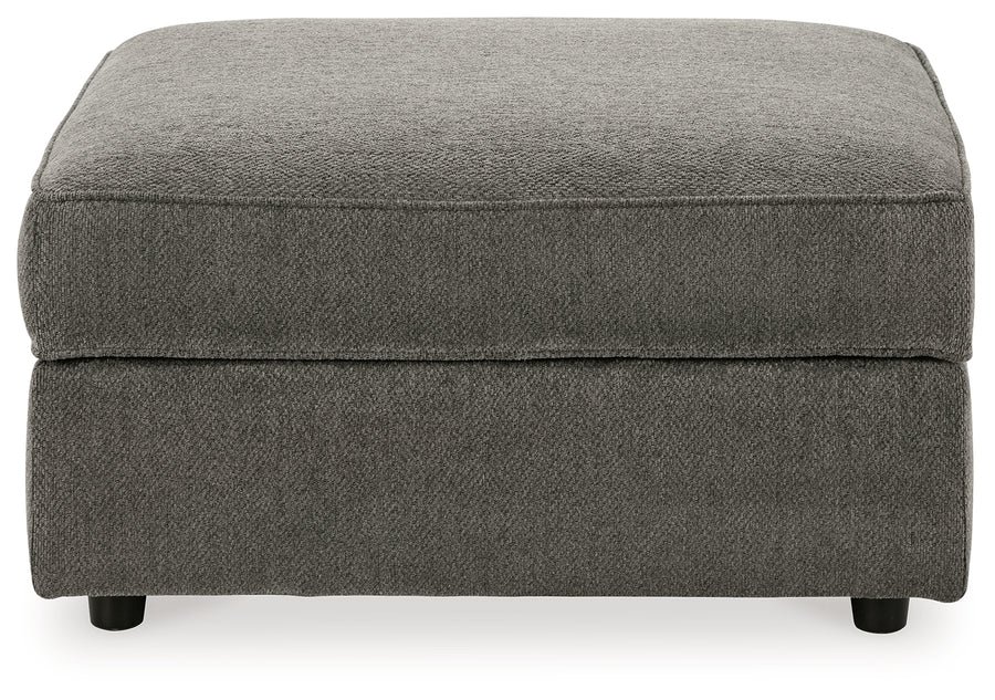 Matching upholstered storage ottoman with removable lid, plush cushioning, and hidden storage compartment.