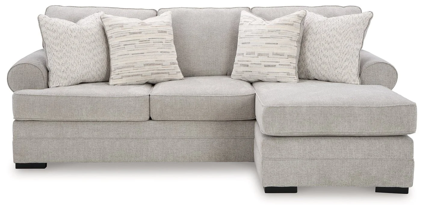 Modern reversible sofa chaise with textured polyester upholstery, movable ottoman, plush cushions, and contemporary styling.