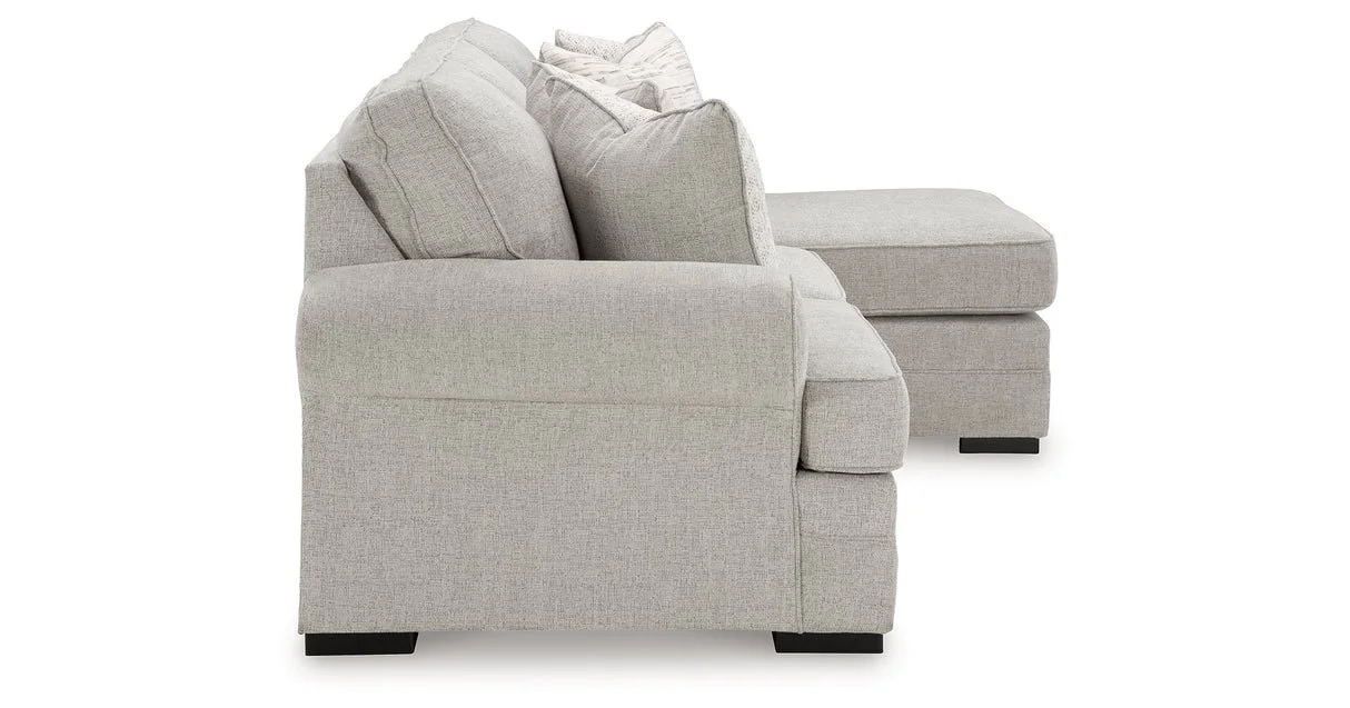 Modern reversible sofa chaise with textured polyester upholstery, movable ottoman, plush cushions, and contemporary styling.