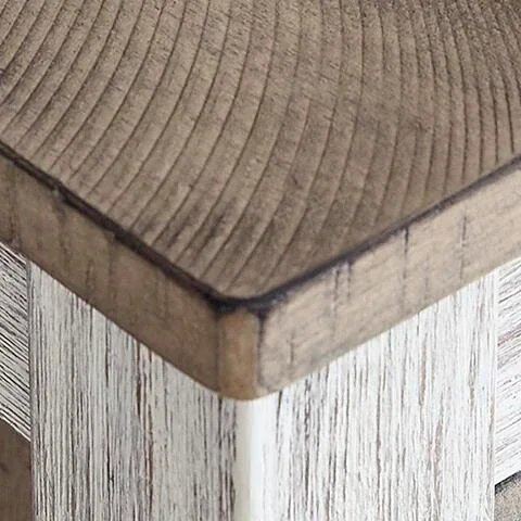 Close-up of the Seaside dining set showcasing the plank-style tabletop, distressed finish, upholstered seat, and built-in storage details.
