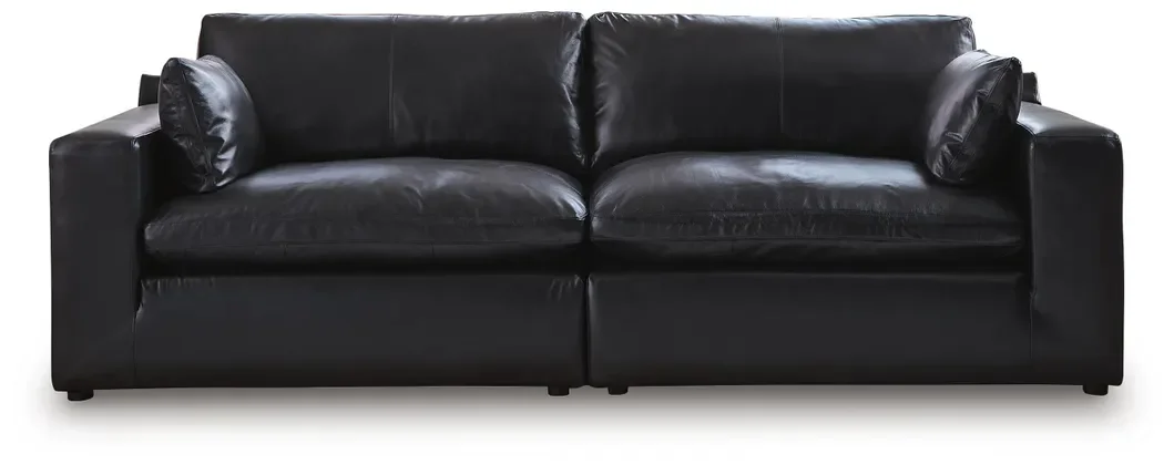 Contemporary modular loveseat with top-grain leather seating, feather-fiber cushions, bolster pillows, and two-piece modular design.