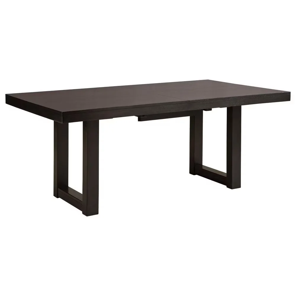 Rectangular butterfly leaf dining table with a dark gray-brown wood finish and a self-storing extension leaf.