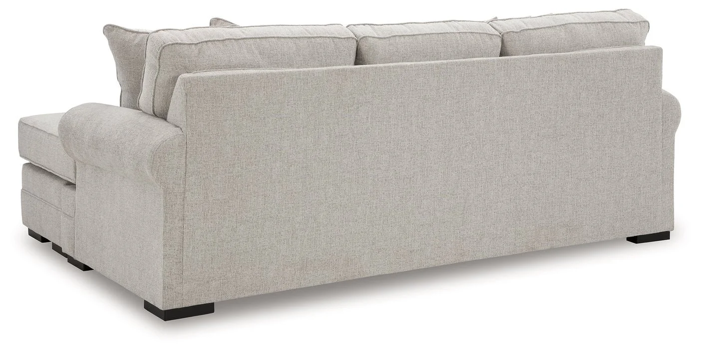 Modern reversible sofa chaise with textured polyester upholstery, movable ottoman, plush cushions, and contemporary styling.