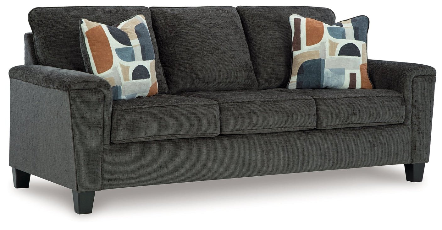 Contemporary sofa with soft polyester upholstery, tapered faux wood legs, and coordinating accent pillows.