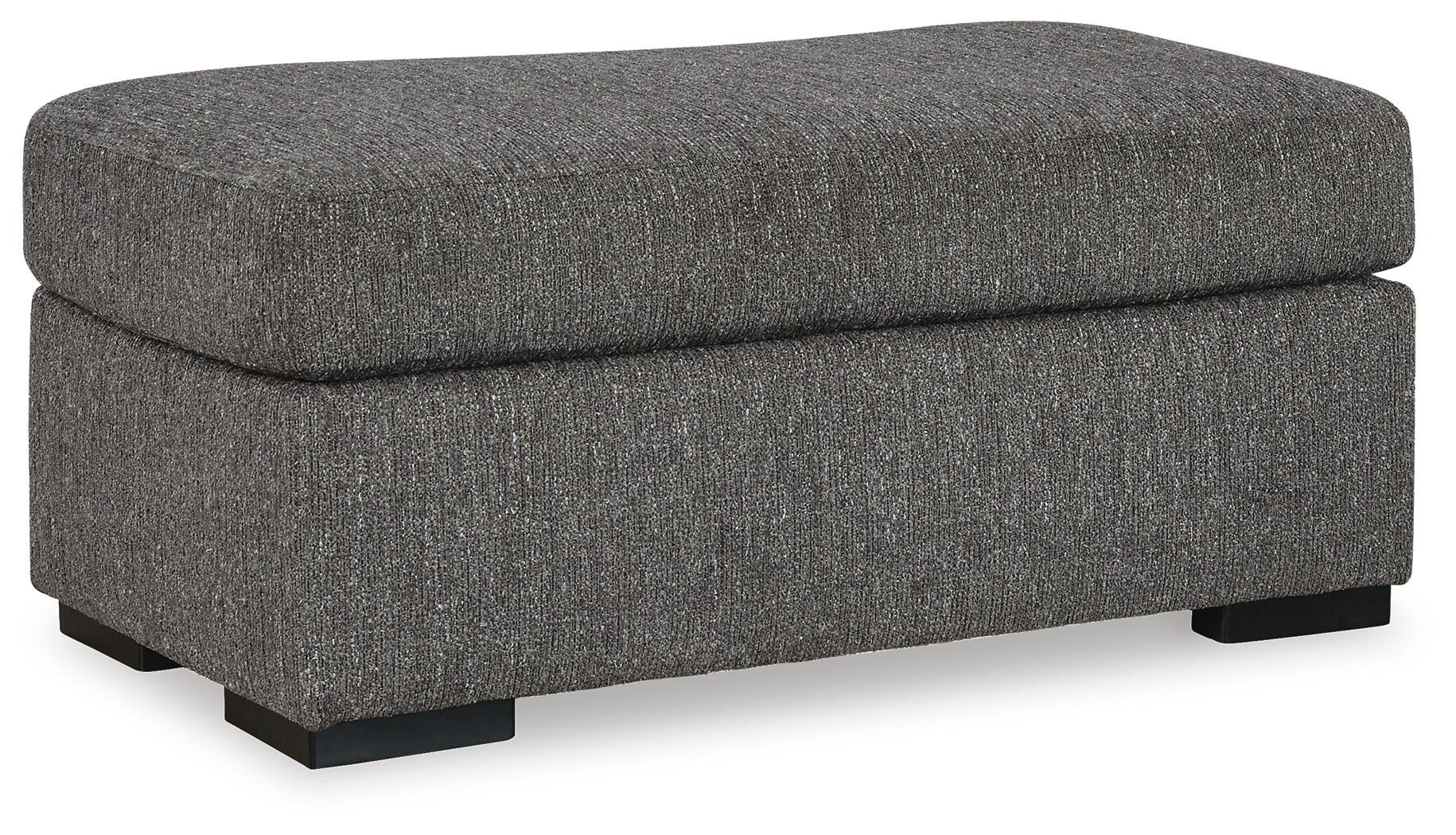 Matching upholstered ottoman with soft polyester fabric, firm foam cushioning, and faux wood feet.