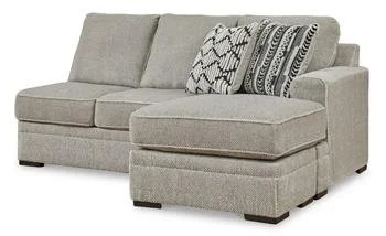 Contemporary dual-chaise sectional with soft polyester upholstery, reversible cushions, plush seating, and coordinating accent pillows.