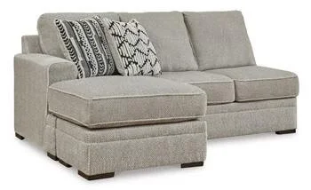 Contemporary dual-chaise sectional with soft polyester upholstery, reversible cushions, plush seating, and coordinating accent pillows.