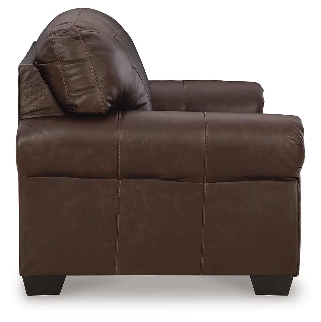 Matching leather loveseat with top-grain leather seating, roll arms, decorative nailhead trim, and supportive foam cushions.