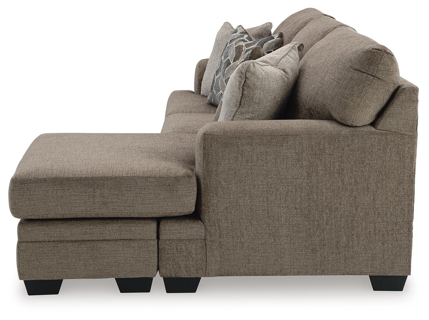 Modern reversible sofa chaise with soft polyester upholstery, movable ottoman, plush cushions, and a contemporary silhouette.