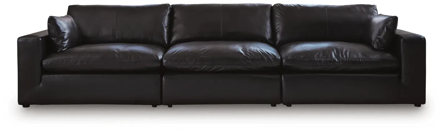 Modern modular leather sofa with top-grain leather seating, feather-fiber cushions, bolster pillows, and flexible three-piece configuration.
