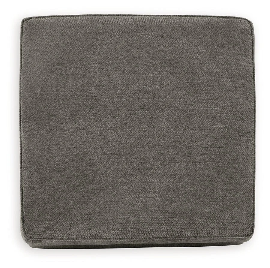 Matching upholstered storage ottoman with removable lid, plush cushioning, and hidden storage compartment.