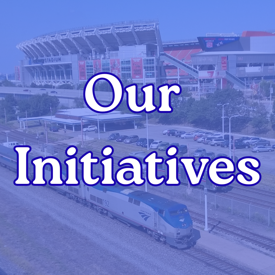 An Amtrak train in Cleveland outside a stadium with the text 'Our Initiatives' overlaid.