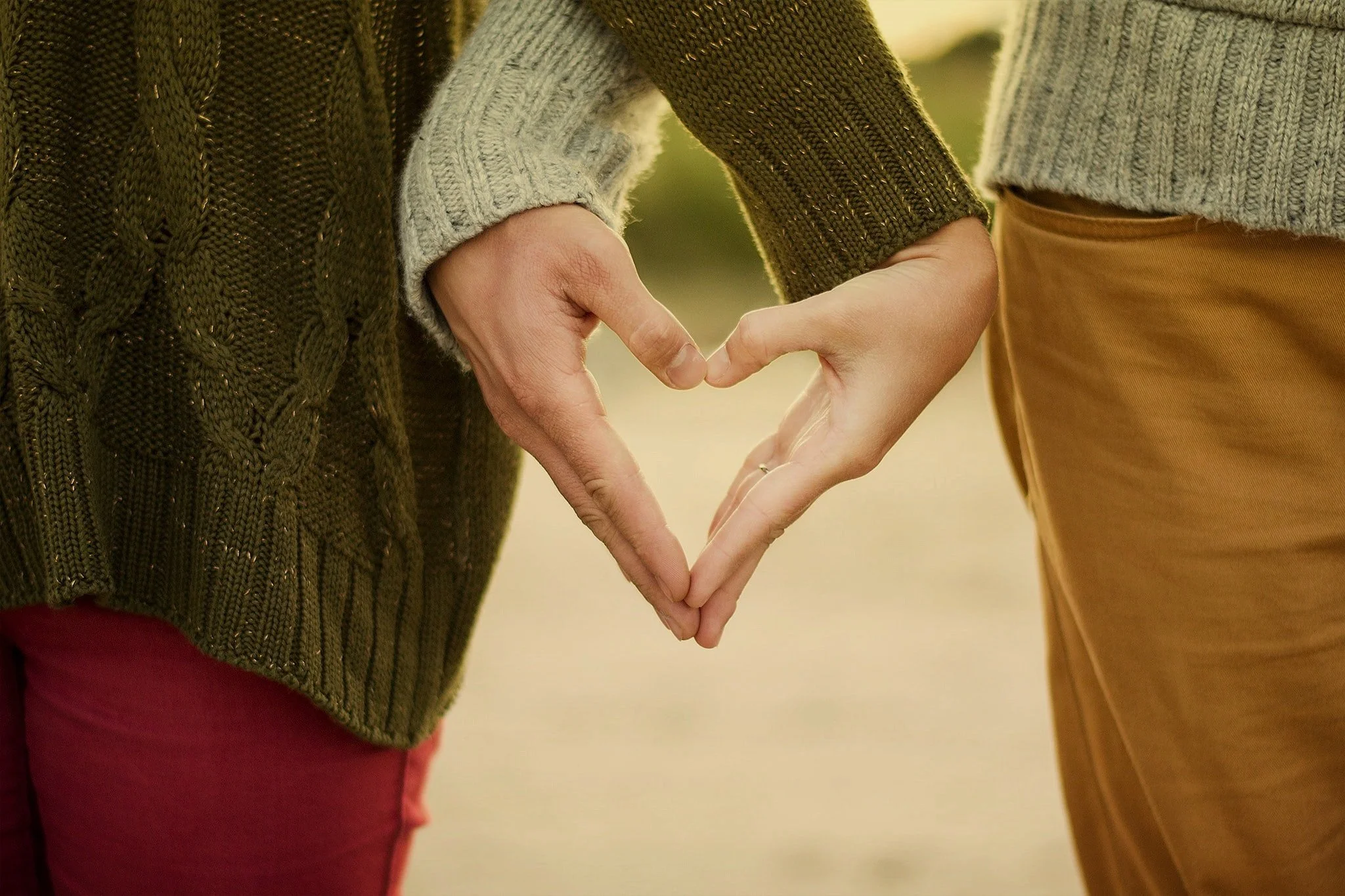Couple forming a heart with their hands - Kristina Litvjak Unsplash
