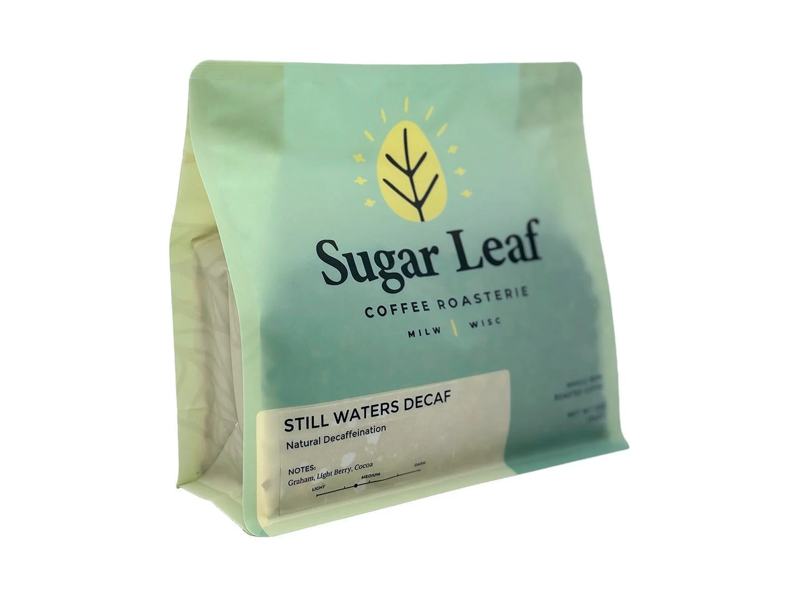 Angled view of a teal and cream 12 oz bag of Sugar Leaf Still Waters Decaf whole bean coffee