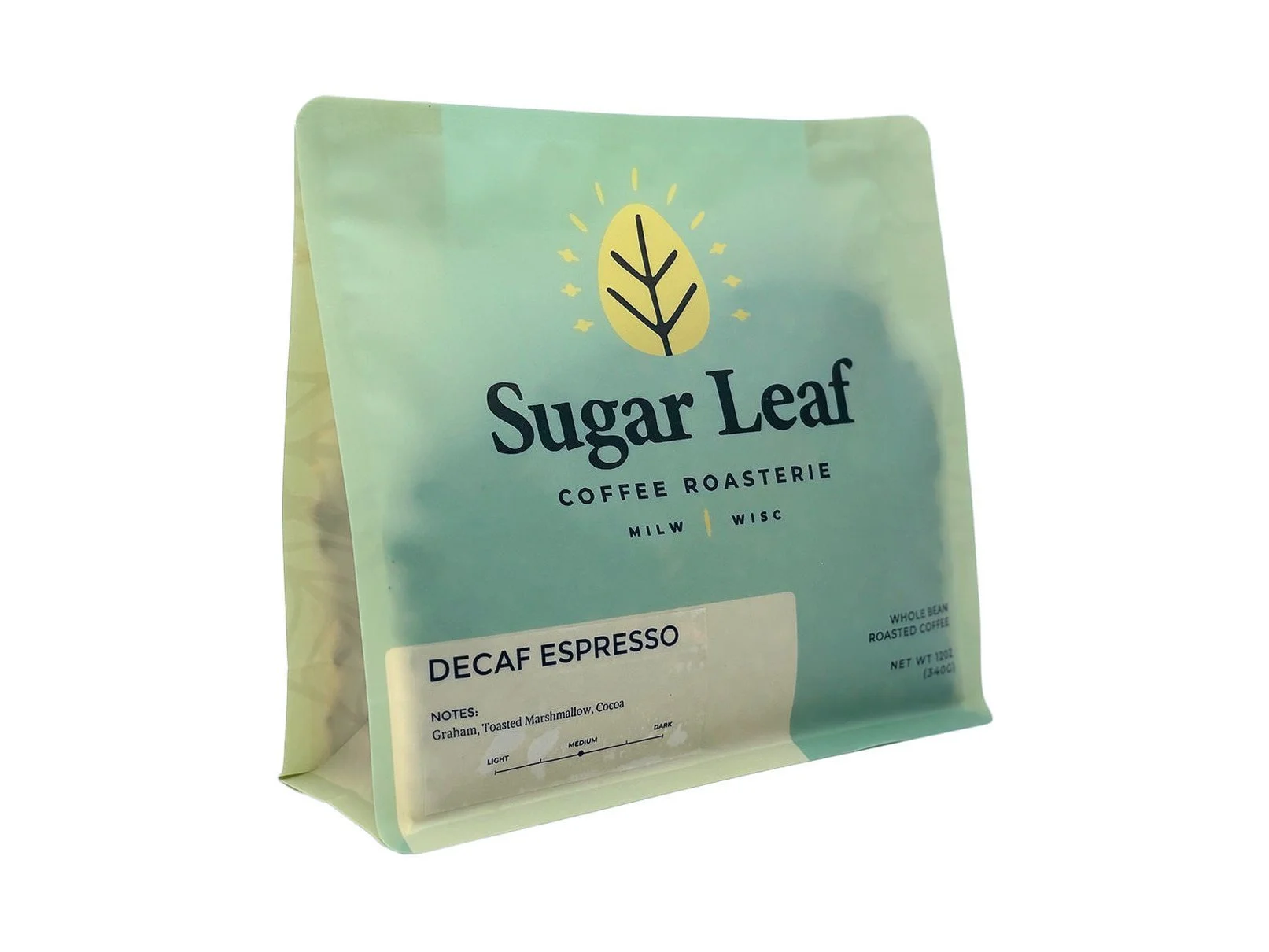 Angled view of a teal and cream 12 oz bag of Sugar Leaf Decaf Espresso whole bean coffee