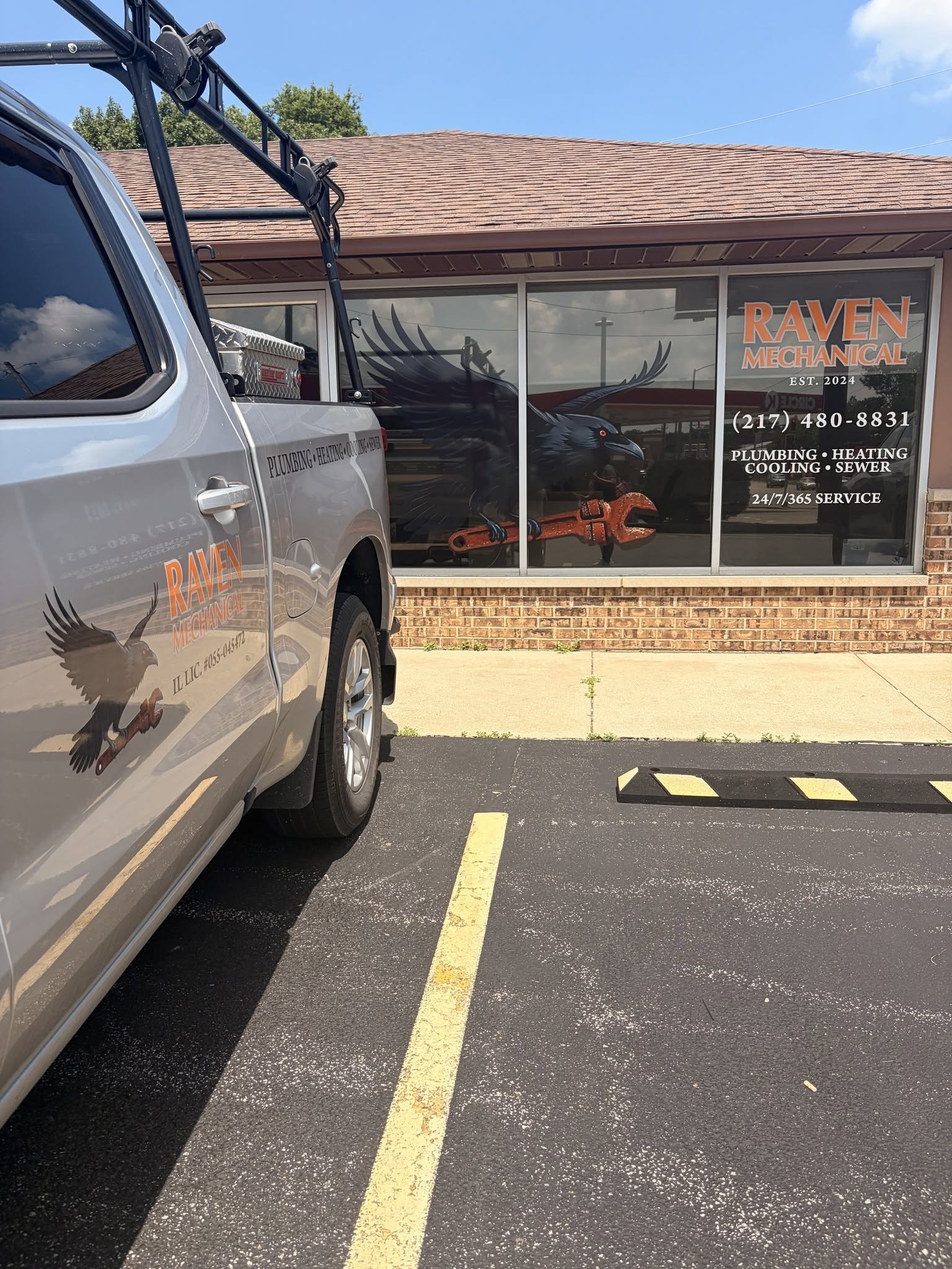 Picture of front office building of Raven Mechanical with grey truck parked in front