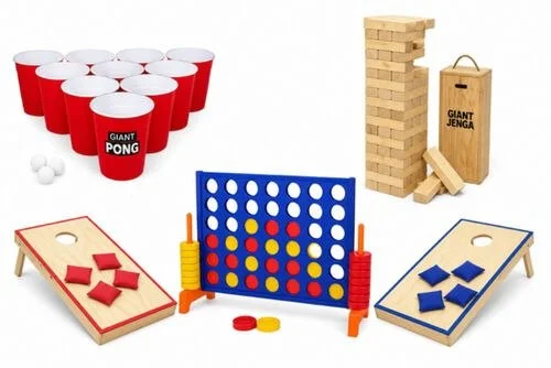 A collection of classic indoor and outdoor game sets, including beer pong cups with balls, a Jenga tower with a box, a giant connect four game, and two mini cornhole boards with red and blue bean bags.
