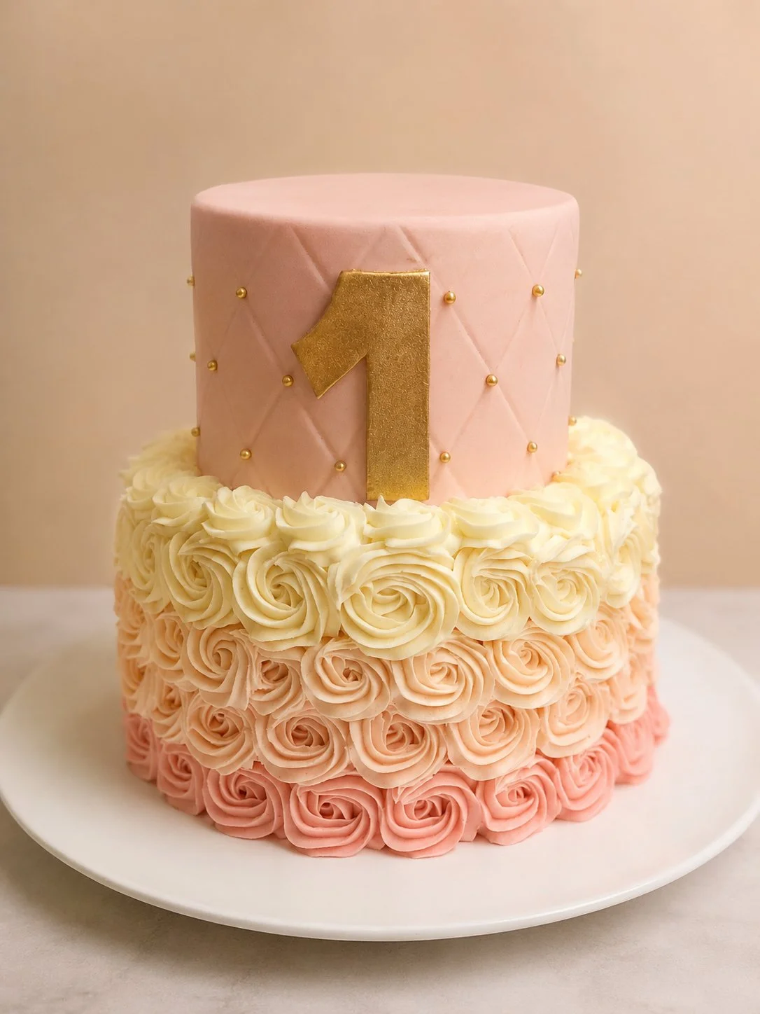 Pink tiered cake with a number 1 and a lower tier of piped rosettes.