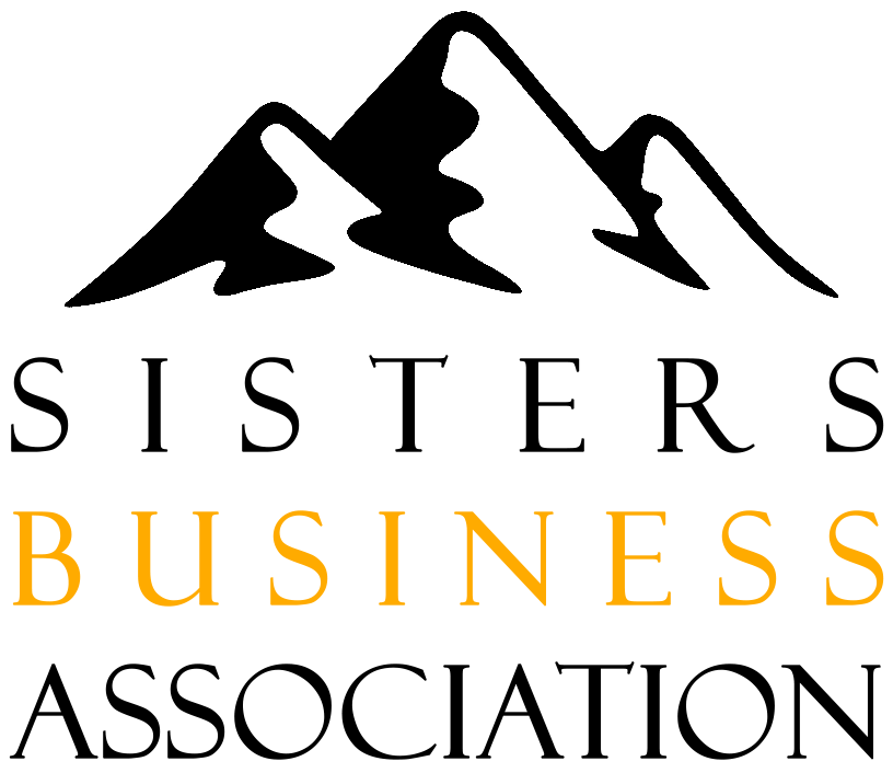 White background with the words 'Sisters Business Association' in large, black and gold letters at the bottom. A graphic with three stylized mountains is above the text.